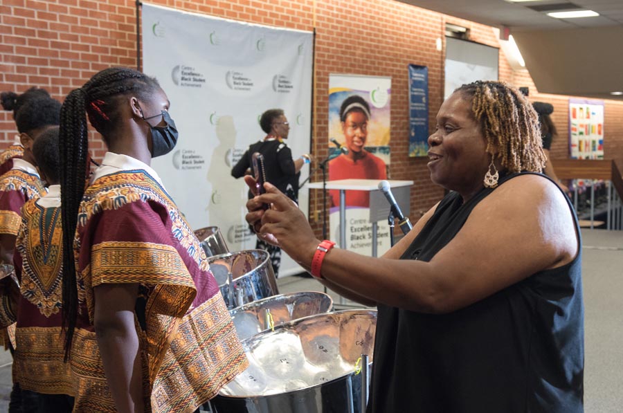 An audience member taking a picture of a student from the Africentric Alternative School. Open Gallery